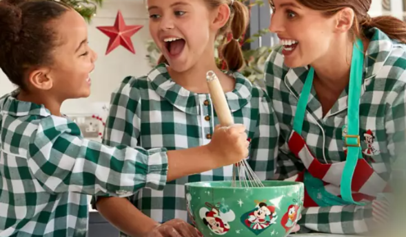 Disney Christmas tree toppers: A family baking in the kitchen in a Disney mixing bowl.