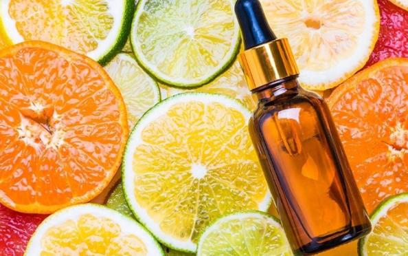 Best-selling skin products: Vitamin C Serum for the face with citrus fruit in the background.