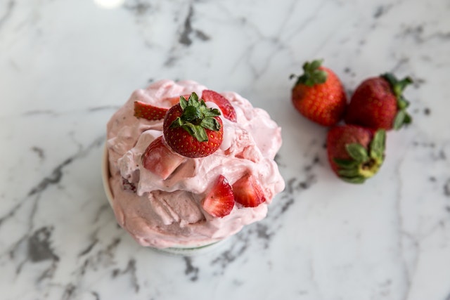 Homemade strawberry ice cream with strawberries made for National Ice Cream Day