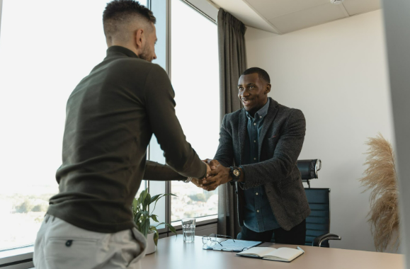 Two men shaking hands because they were searching for the best home estate agents.