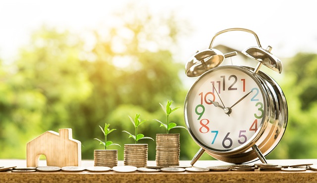Finance image with coins and an alarm clock on the side for the average household bills per month