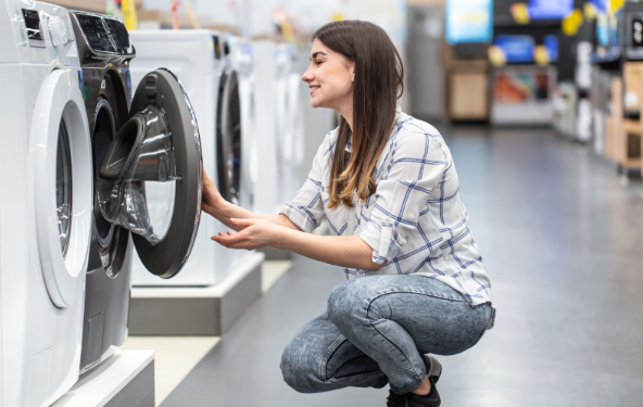 A woman shopping for her most-wanted Appliances Direct washing machine store.