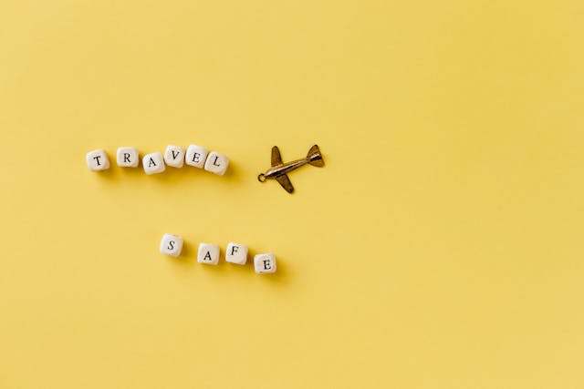 Image: Beads with letters arranged to form the sentence ‘Travel safe’ and an aeroplane pendant Beads with letters arranged to form the sentence ‘Travel safe’ and an aeroplane pendant