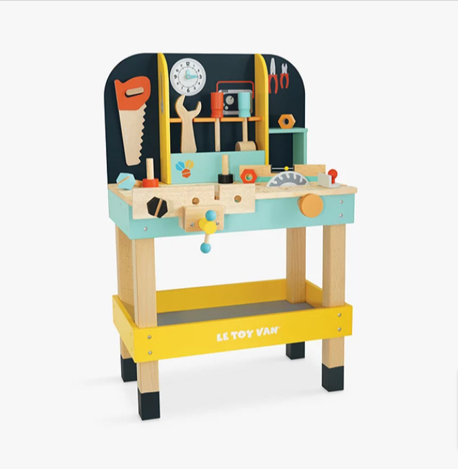 A wooden toy workbench playset standing in front of a white background