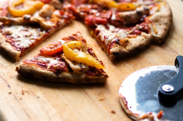 Pizza from the best affordable Italian restaurant in London resting on a cutting board
