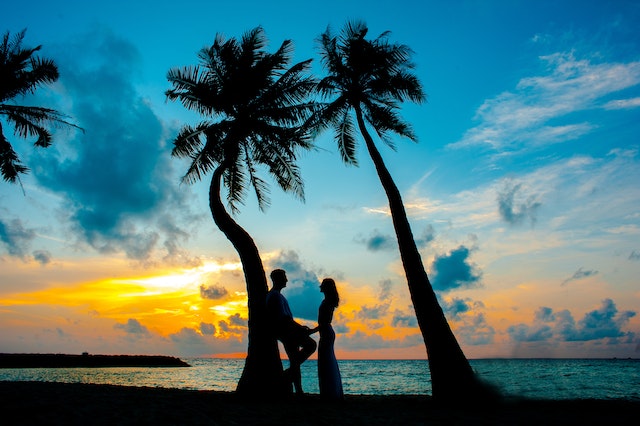 Love Island 2023: The silhouette of a couple on an island under palm trees