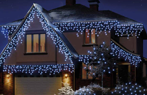 LED white snowing outdoor Christmas light decorations on a house.
