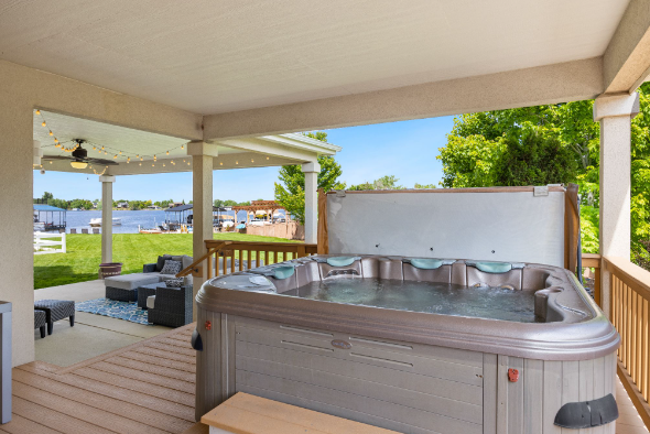 One of the hot tubs on eBay placed on a terrace with patio furniture.