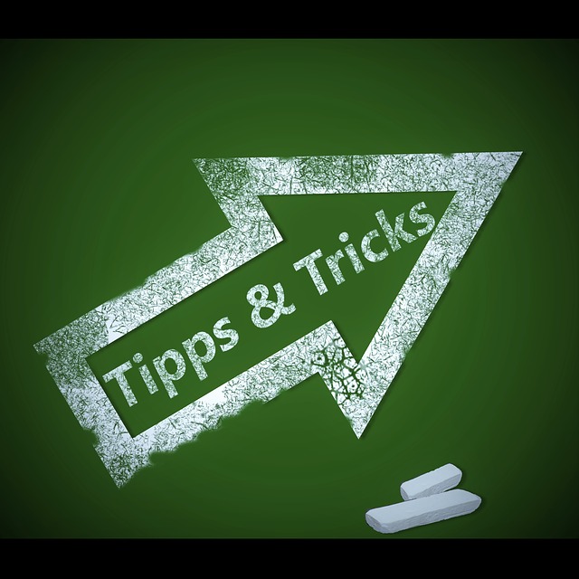 Arrow with tips and tricks caption written on a blackboard as background.