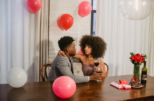 Valentine’s Day Dinner for Two: A couple enjoying a romantic dinner with a bottle of wine.