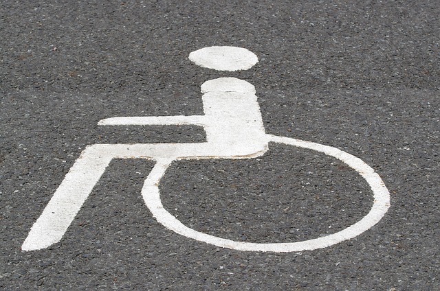 Pictogram of a white wheelchair painted on the side of the road