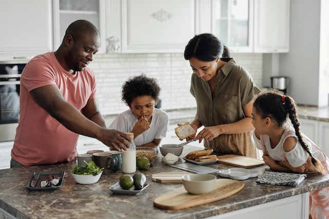 Image: A family of four preparing a meal that will be cooked in a Ninja air fryer A family of four preparing a meal that will be cooked in a Ninja air fryer