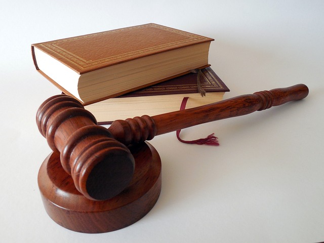 Solicitor Fees When Selling A House: Two law books and a brown gavel on a plain background.