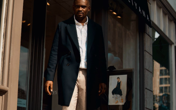 Image: Long winter coats for men: A man walking out of the store wearing a long winter coat Long winter coats for men: A man walking out of the store wearing a long winter coat