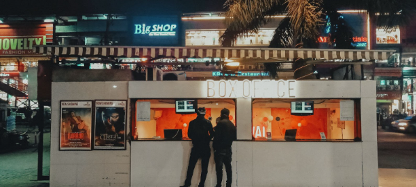 Two people purchasing drive-in cinema tickets