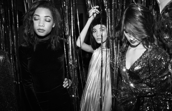 Image: Three women at a party who saved money on their dresses for New Year’s Eve. Three women at a party who saved money on their dresses for New Year’s Eve.