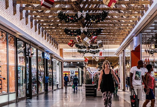 People walking and browsing in a shopping centre which has been decorated for Christmas