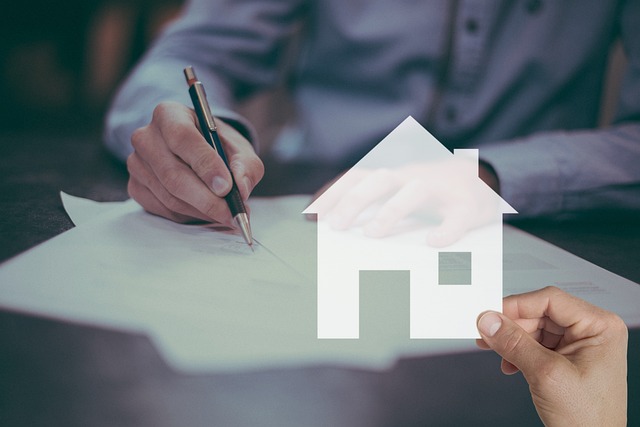 House cutout with a blurry background of a person signing a home insurance contract with Admiral Home insurance