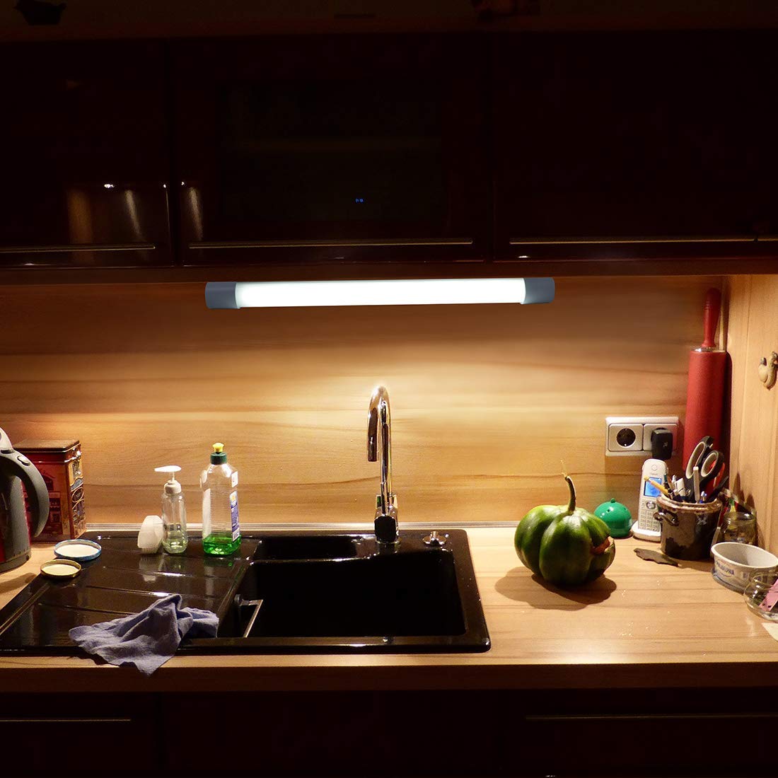 Image: brown cupboards with kitchen lights under cabinets giving light to the sink and kitchen essentials brown cupboards with kitchen lights under cabinets giving light to the sink and kitchen essentials