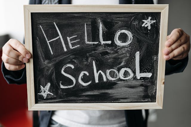 Getting ready for back-to-school: A person holding a chalkboard