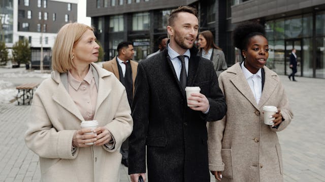 Autumn capsule wardrobe: Coworkers wearing coats and walking outside