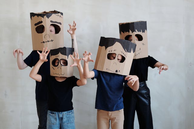 Family Halloween costume ideas: A family wearing cardboard masks