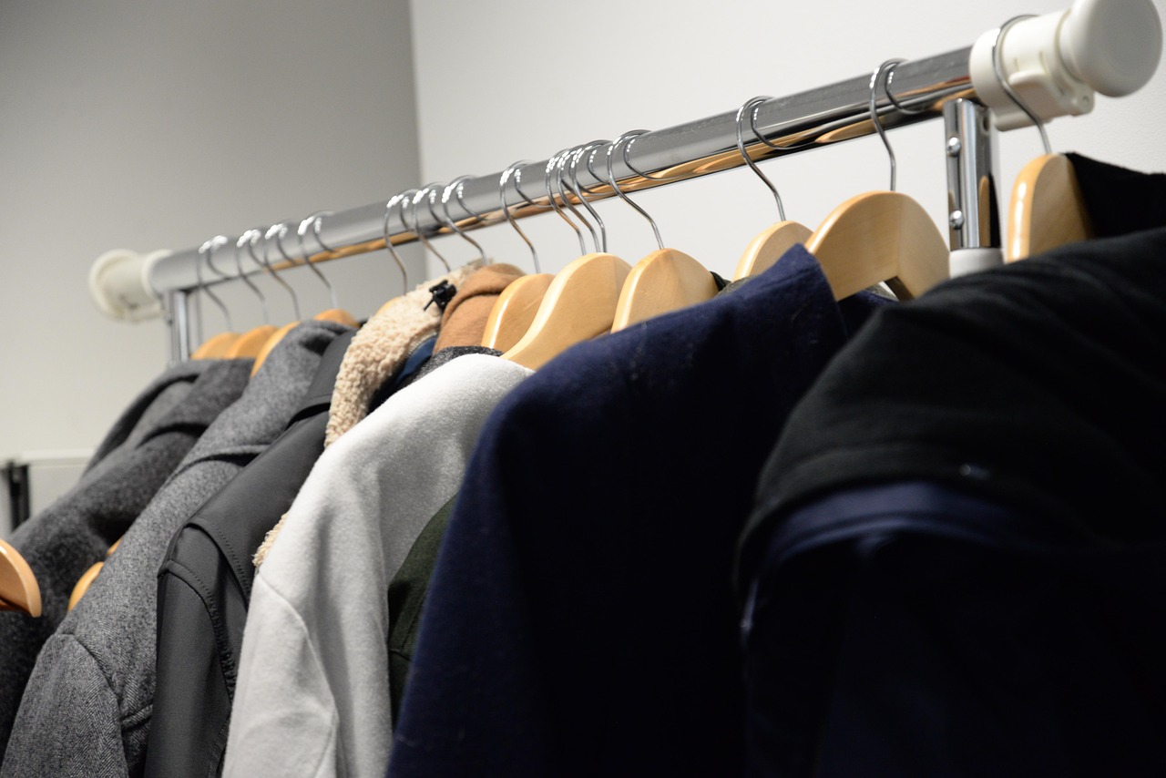 The best coats for fall displayed on a rack using clothing hangers