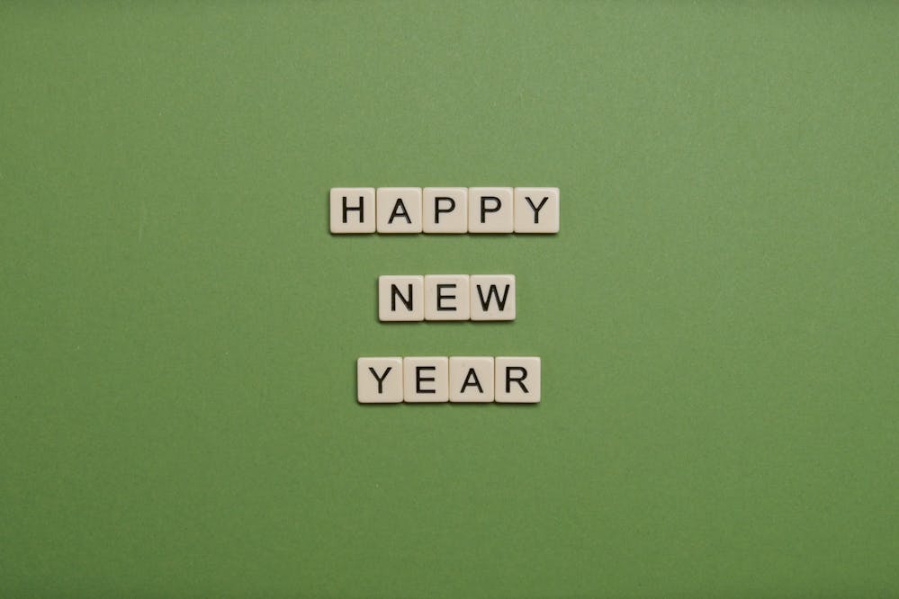 Boxing Day or January sales: Happy New Year tiles on a green background