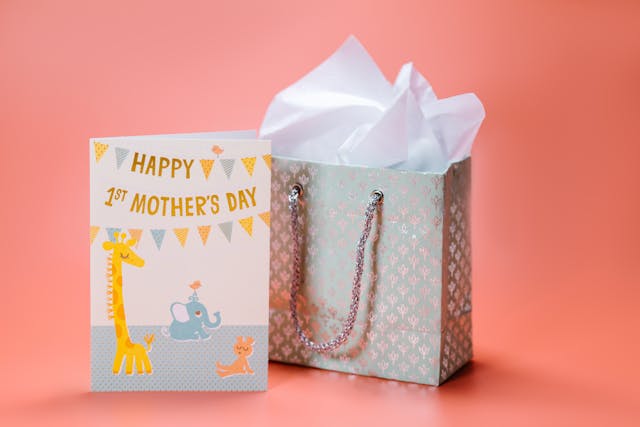 Gift ideas for moms’ first Mother’s Day: A first Mother’s Day card next to a gift bag
