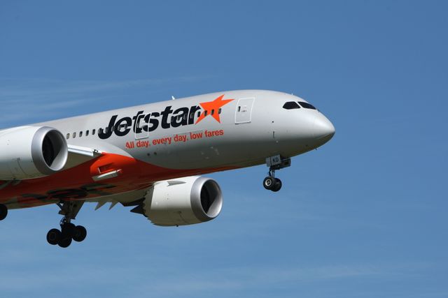 Jetstar airliner approaching landing deploys landing gear