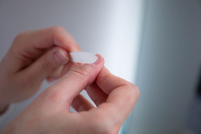 A person filing their nails at home for a no-polish manicure