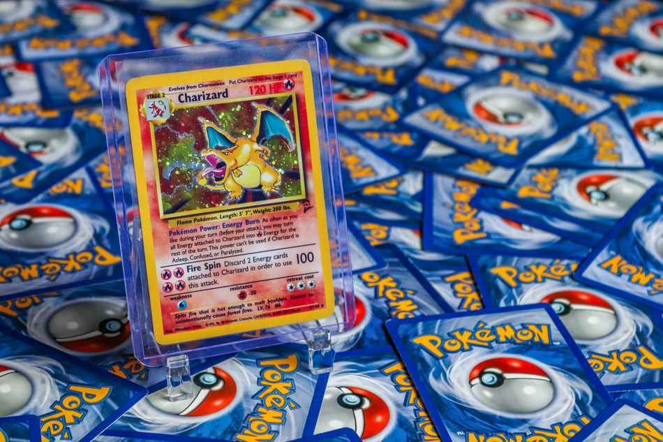 High-value Charizard Pokémon trading card surrounded by various other cards