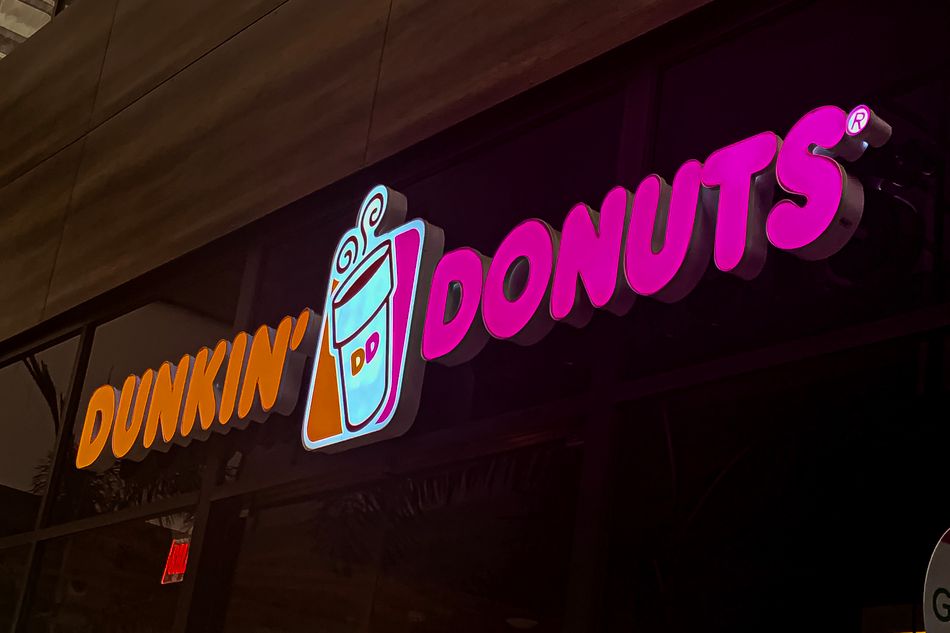 A close-up of a Dunkin' Donuts neon sign