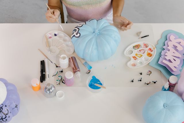 A woman painting Halloween decorations to celebrate Halloween in the UK