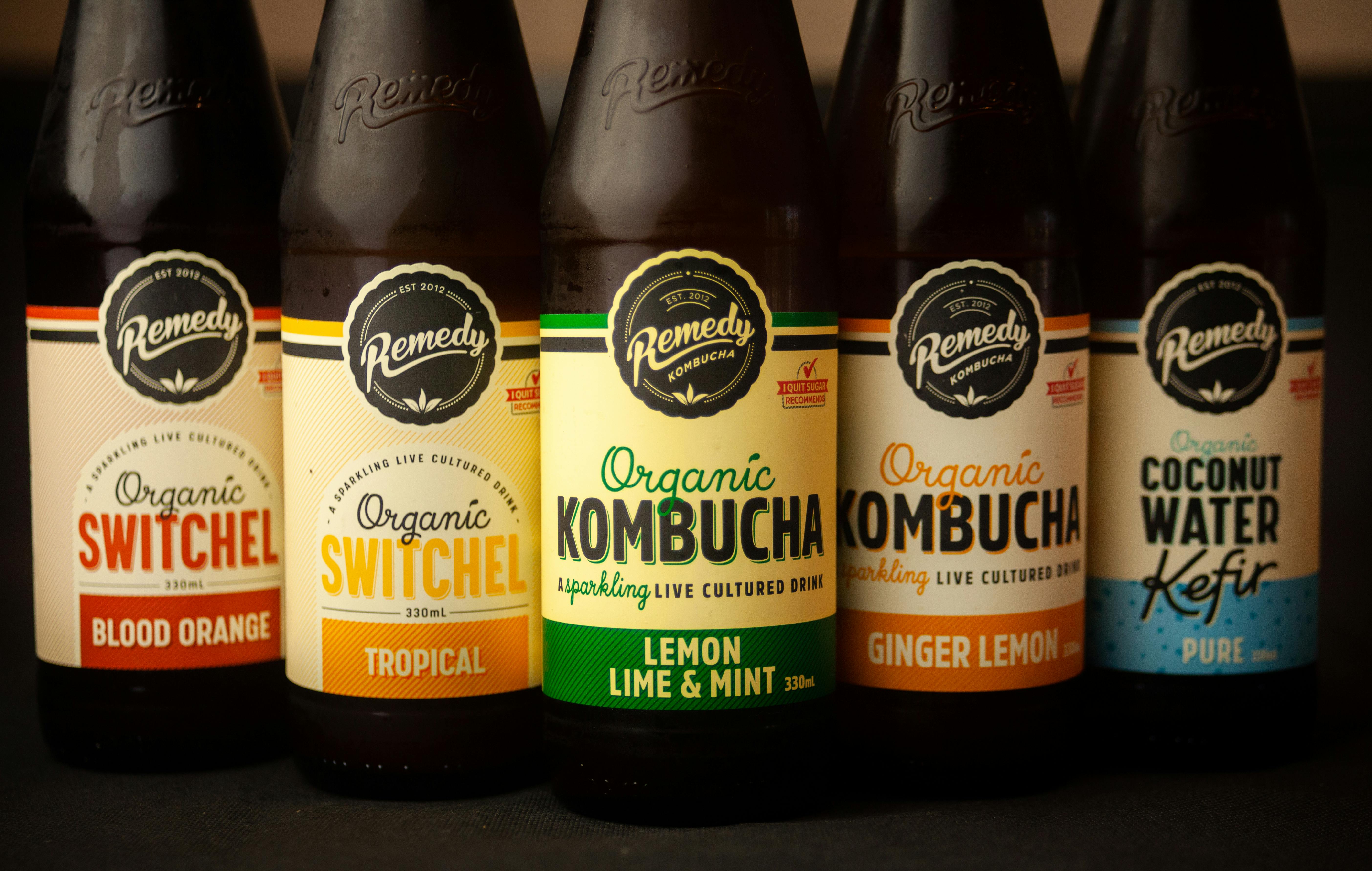 Five bottles of different types of drinks including Kombucha, Switchel, and Water Kefir.