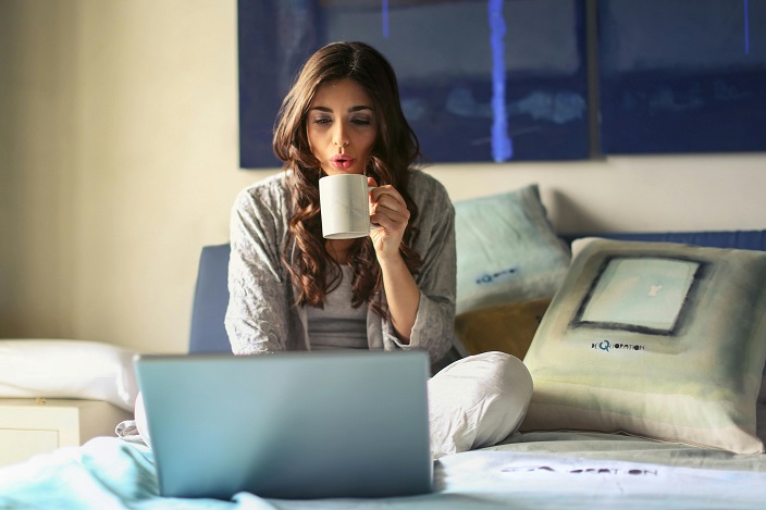 Image showing a woman selling her tickets on the StubHub website from the comfort of her home.