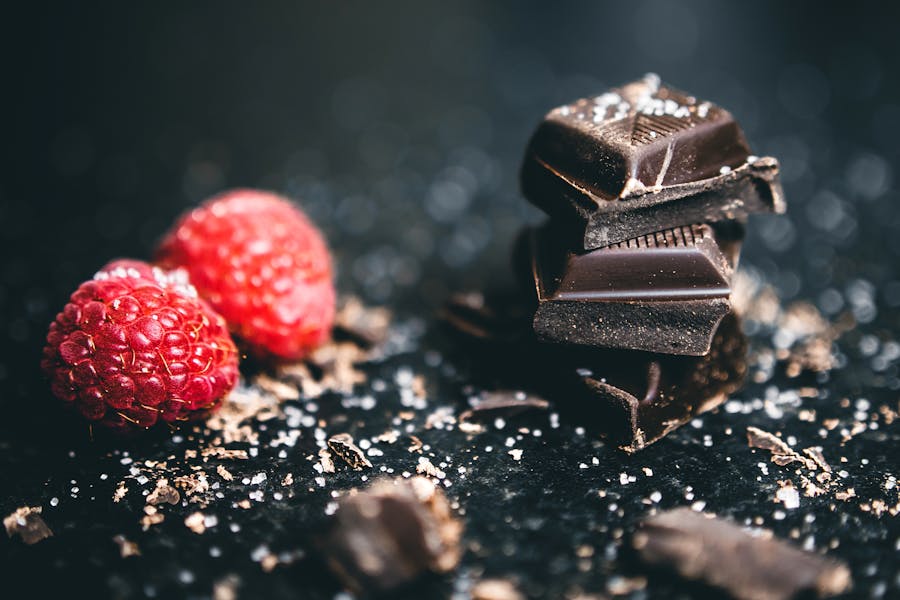 2 raspberries with dark chocolate and salt sprinkled on top