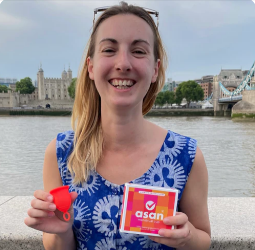 A young woman holding the Asan menstrual cup
