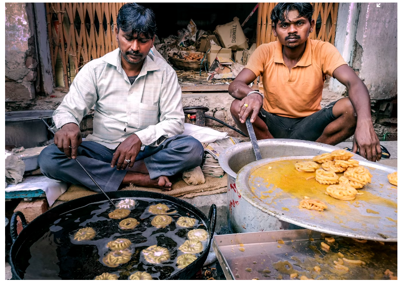 Street food vendors deep fat fry gol gappas which are popular for their spicy and tangy flavour
