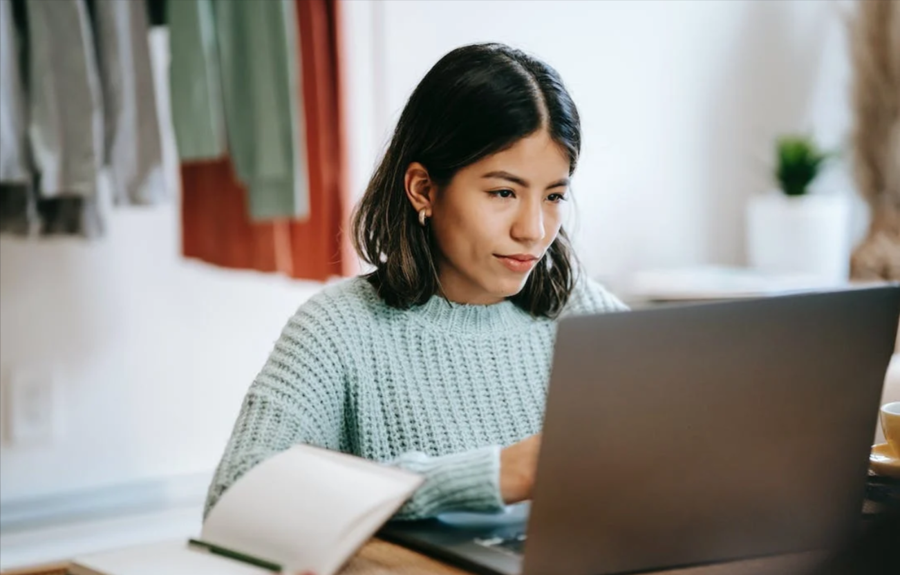 studentessa che è comoda col suo laptop mentre cerca promozioni MoneyGram