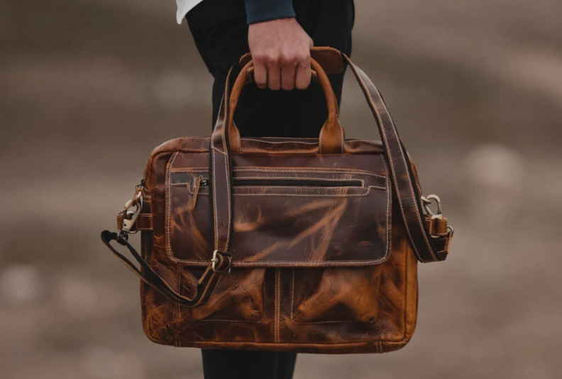Best Father's Day deals: A man holding the antique brown Buffalo leather pilot bag
