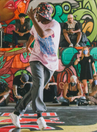 Street dancer performing break dance while wearing Bloch sneakers
