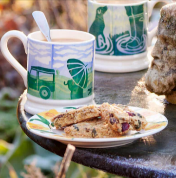 An Emma Bridgewater rainy dog walks 1/2 pint mug and a plate with cookies