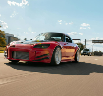 A red Honda S2000 on the road modified by DTE SYSTEMS