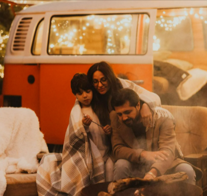 Cozy family camping by festive van