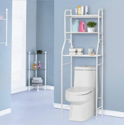 A white toilet system with a bathroom shelf containing detergents behind it