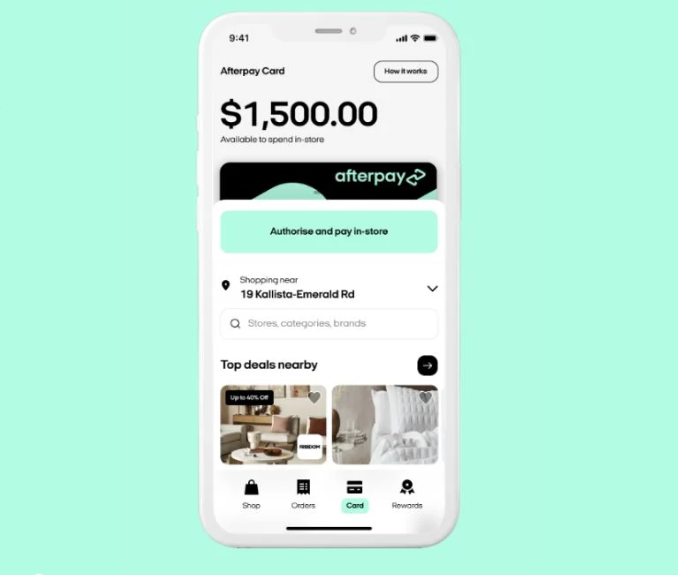Mobile phone over a blue background with the Afterpay app displayed on the screen