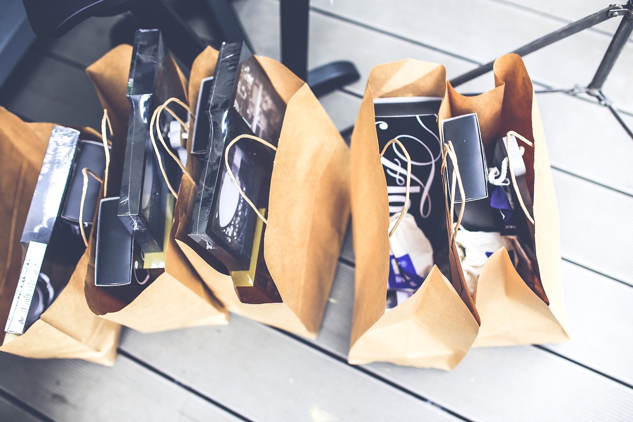 Five brown shopping bags packed with sealed boxes.