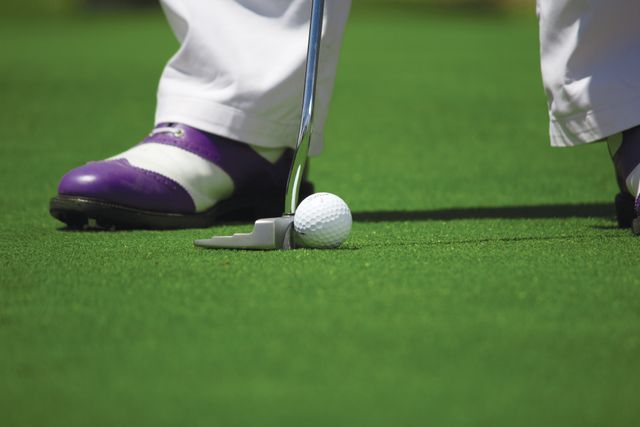 A person playing golf that they saved on with a HotGolf voucher code from Love Discount Vouchers