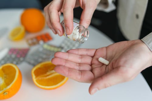 A person taking the supplements they brought from Proactive Healthcare